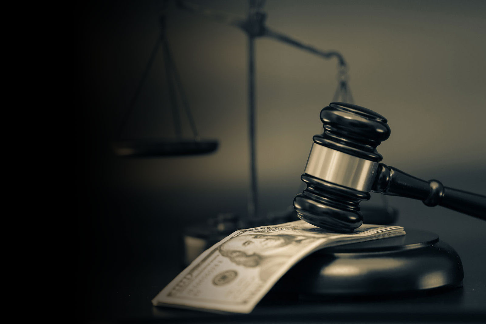 Spiwak-and-Iezza-Home-Page-Banner-8 A gavel resting on a pile of money.
