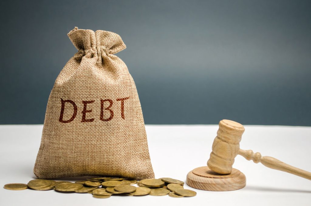 gavel and a bag of debt