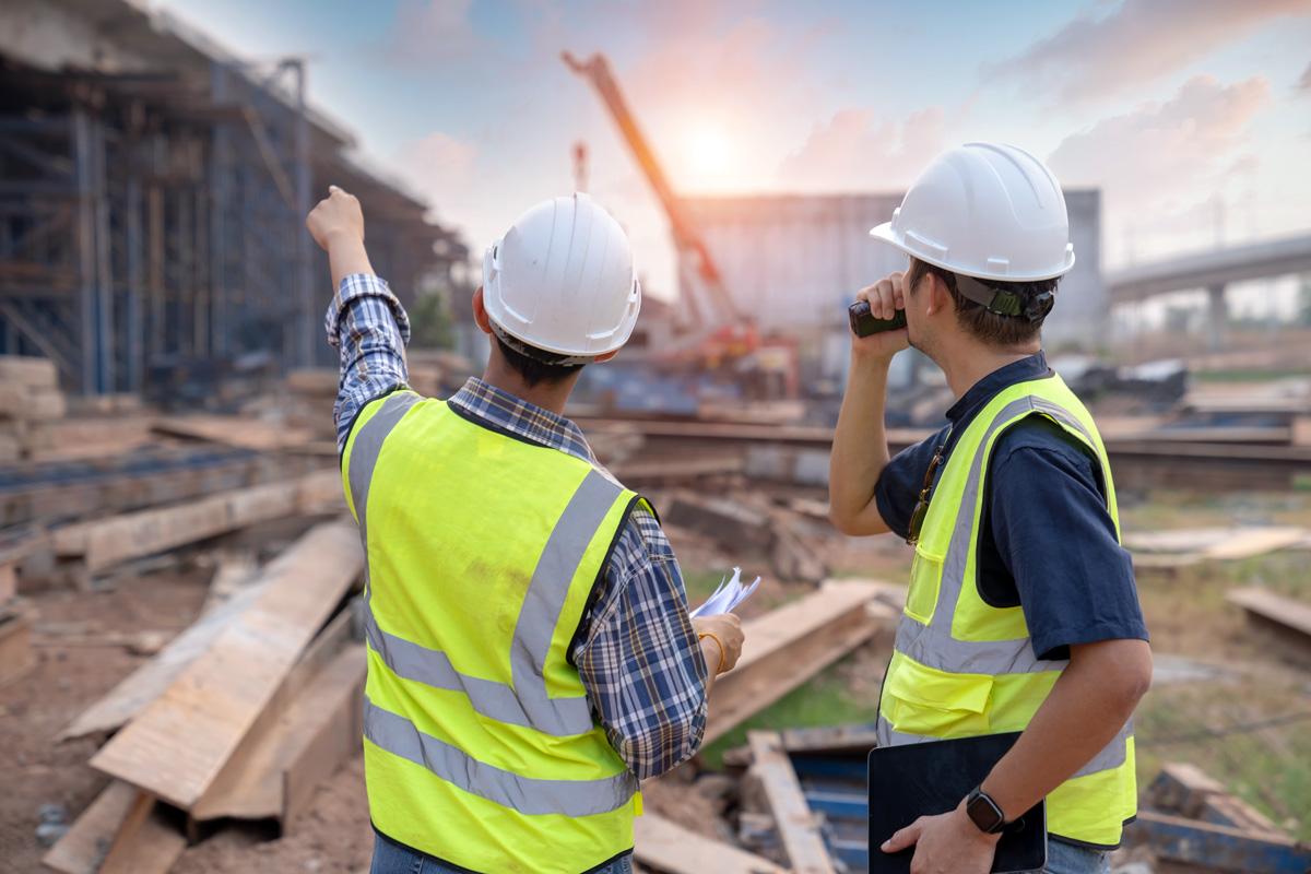 construction workers at a job site construction workers at a construction job site with a building being made
