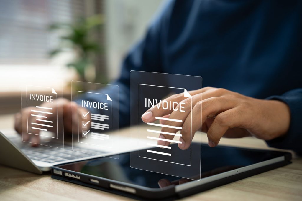 person sending out invoices on the computer